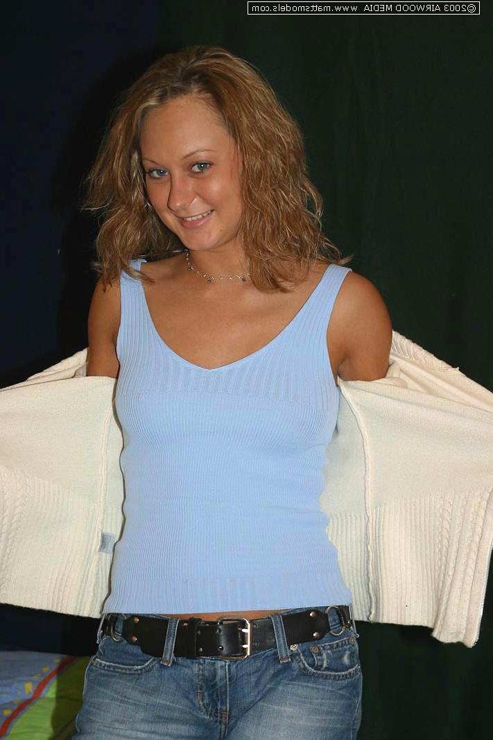 16P Blond amateur Danny undresses before showing her landing strip pussy on a bed