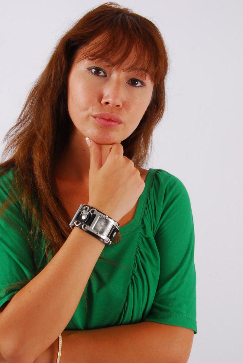 16P Redheaded Asian girl Evita models a Guess style cuff watch during SFW action