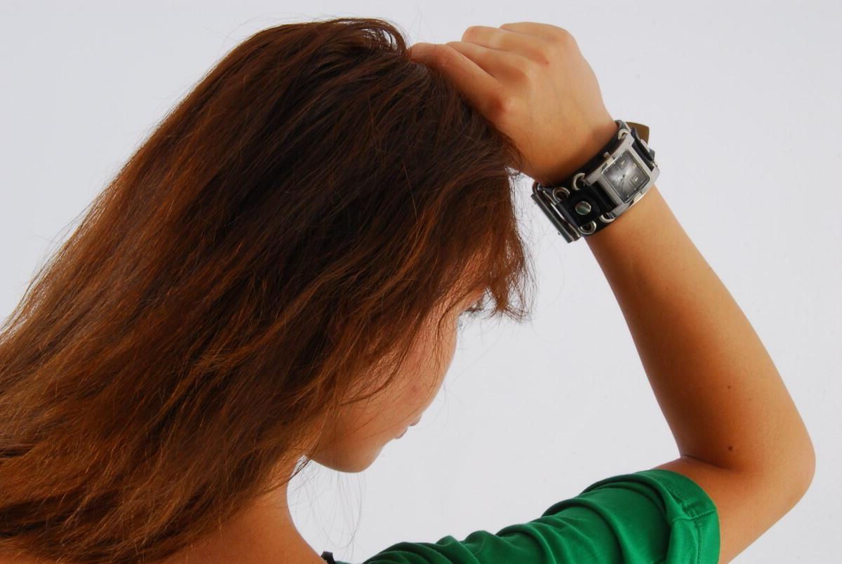 16P Redheaded Asian girl Evita models a Guess style cuff watch during SFW action
