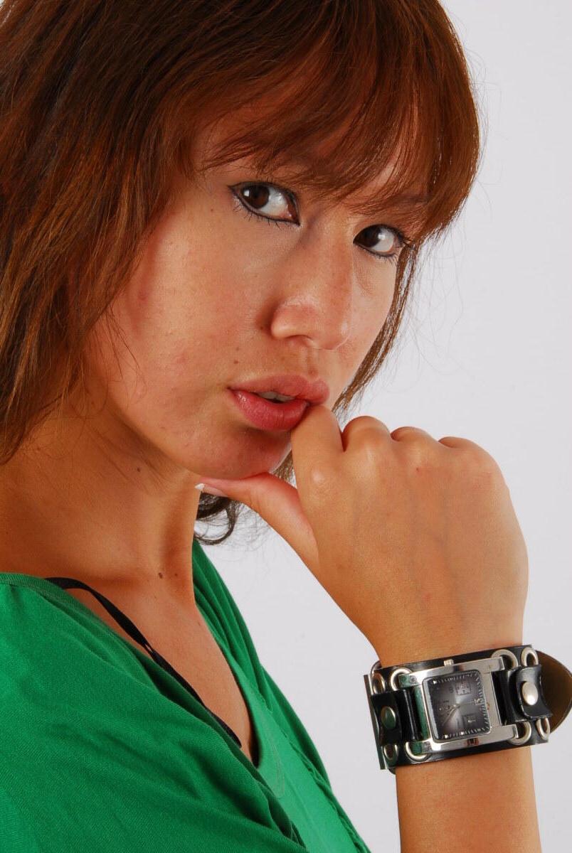 16P Redheaded Asian girl Evita models a Guess style cuff watch during SFW action