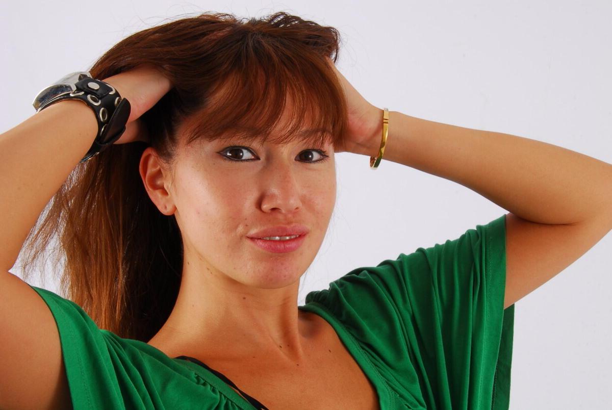 16P Redheaded Asian girl Evita models a Guess style cuff watch during SFW action