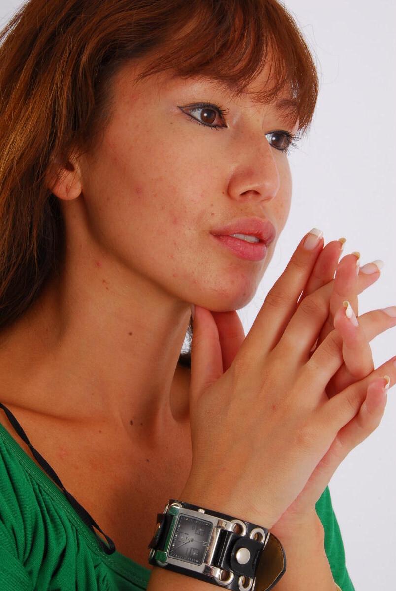 16P Redheaded Asian girl Evita models a Guess style cuff watch during SFW action