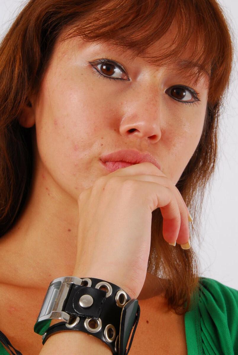 16P Redheaded Asian girl Evita models a Guess style cuff watch during SFW action