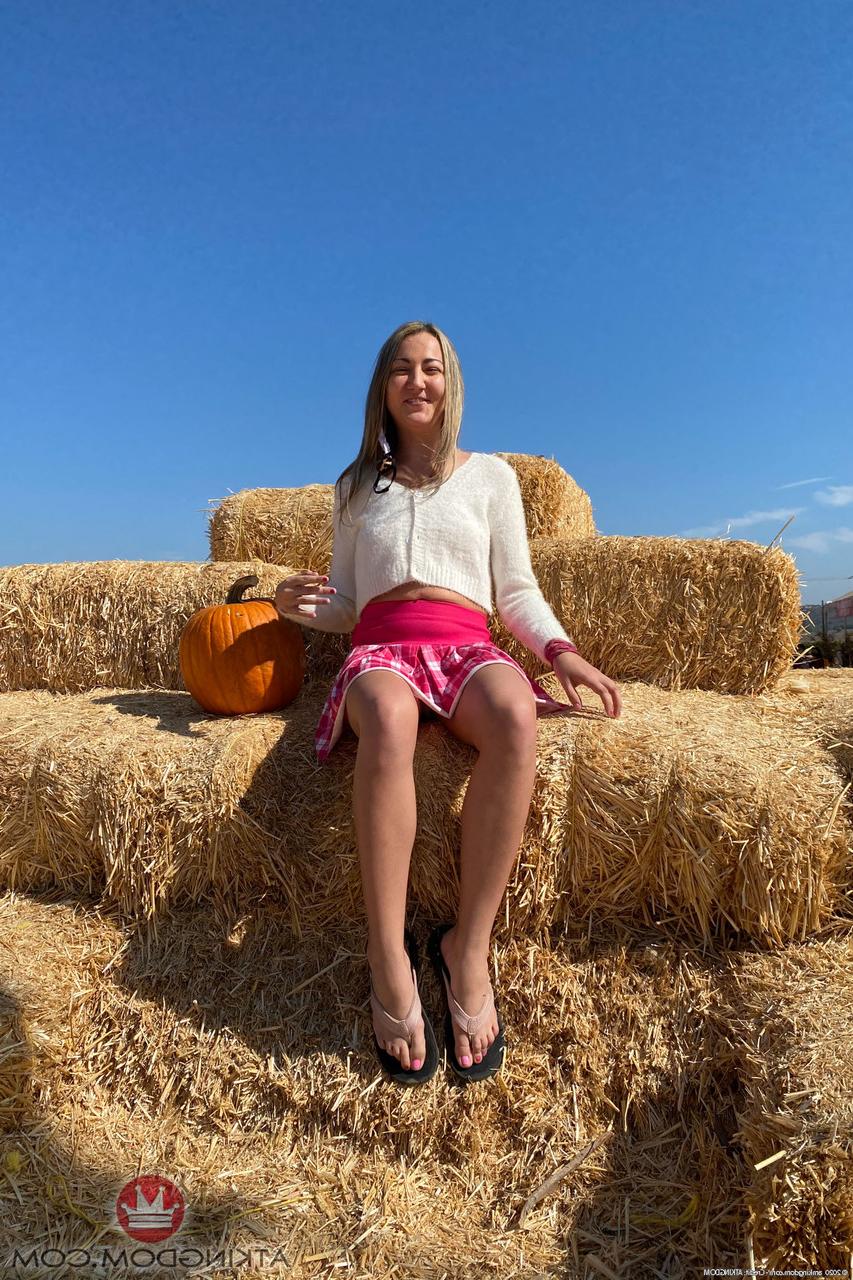 20P Tiny blonde Lily Adams spreads on a patio swing & shows her holes up close