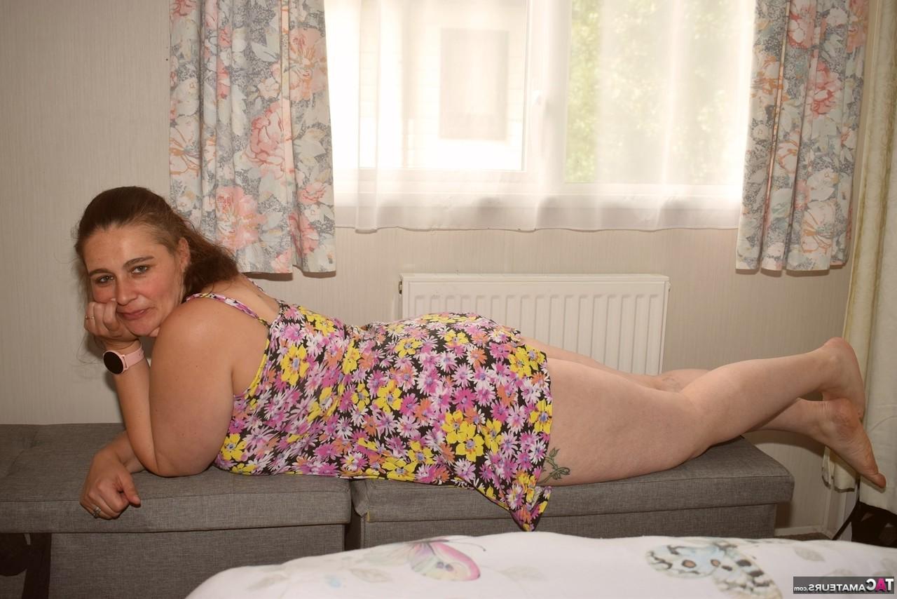 16P Overweight amateur removes a dress to get completely naked near a window