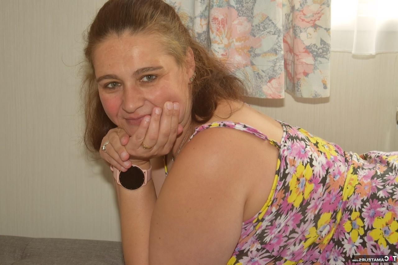 16P Overweight amateur removes a dress to get completely naked near a window