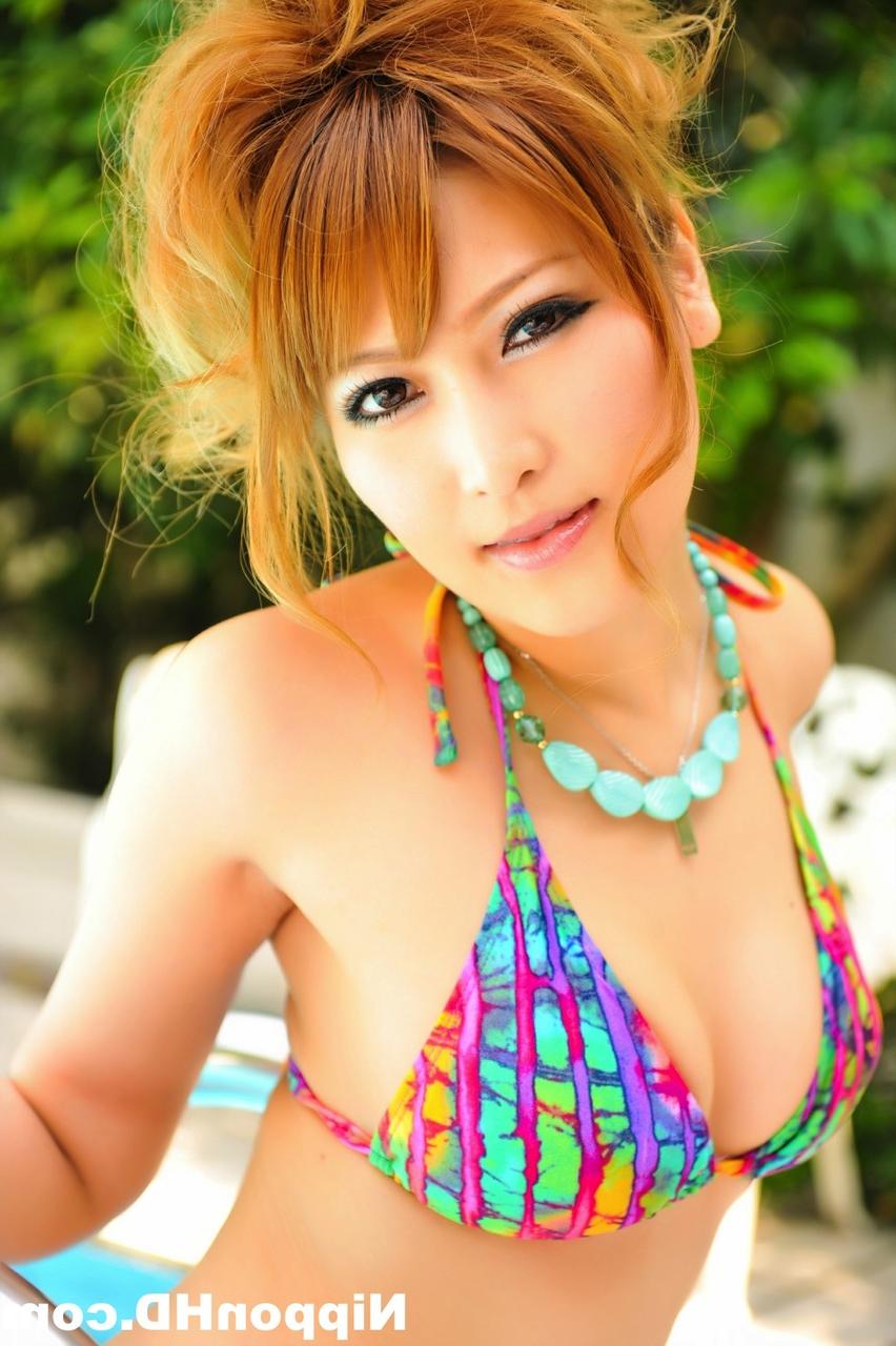 12P Gorgeous Japanese redhead models a bikini next to a swimming pool