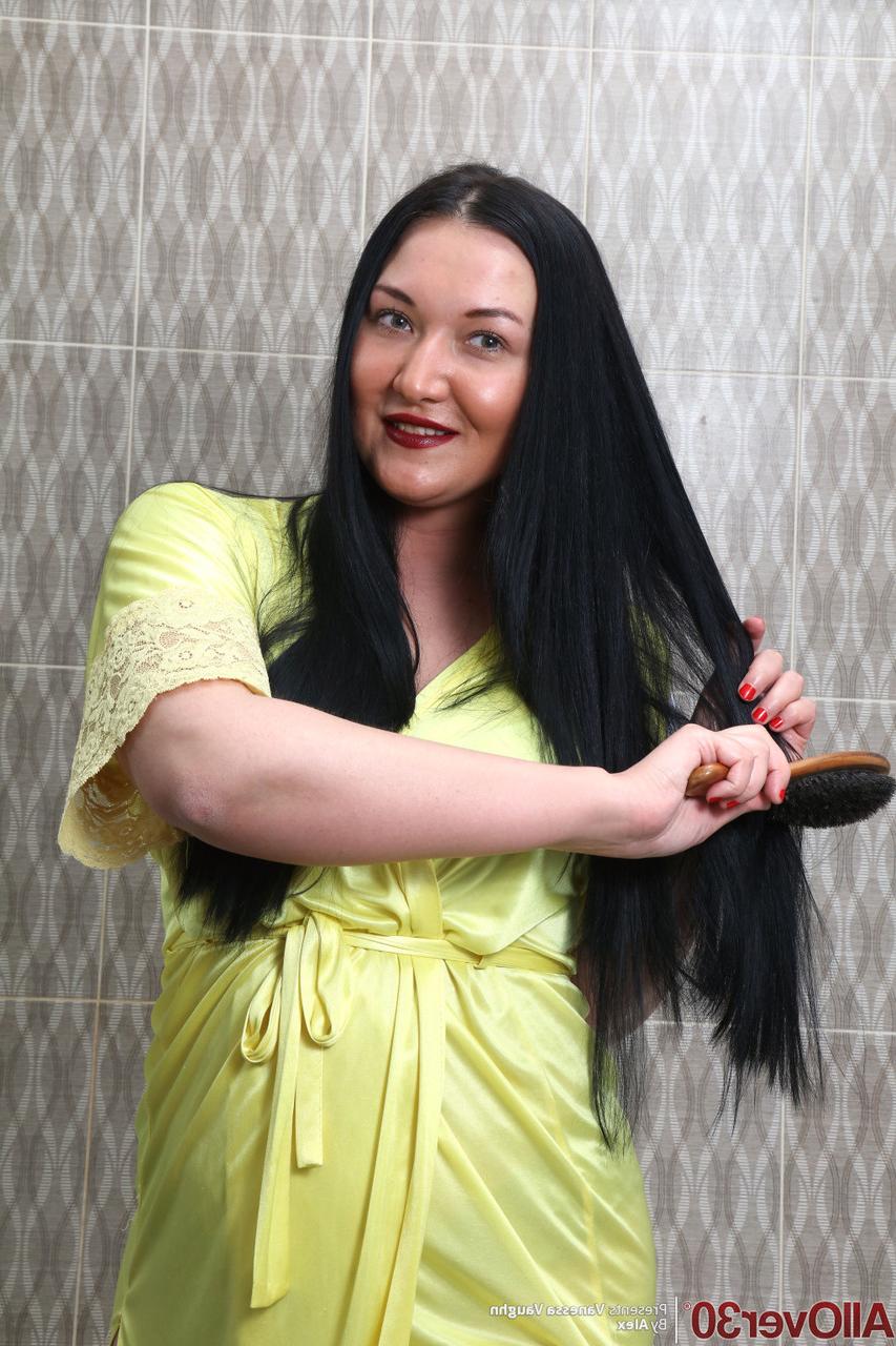 16P Curvy 30 plus brunette Vanessa Vaughn brushes her long hair before bathing