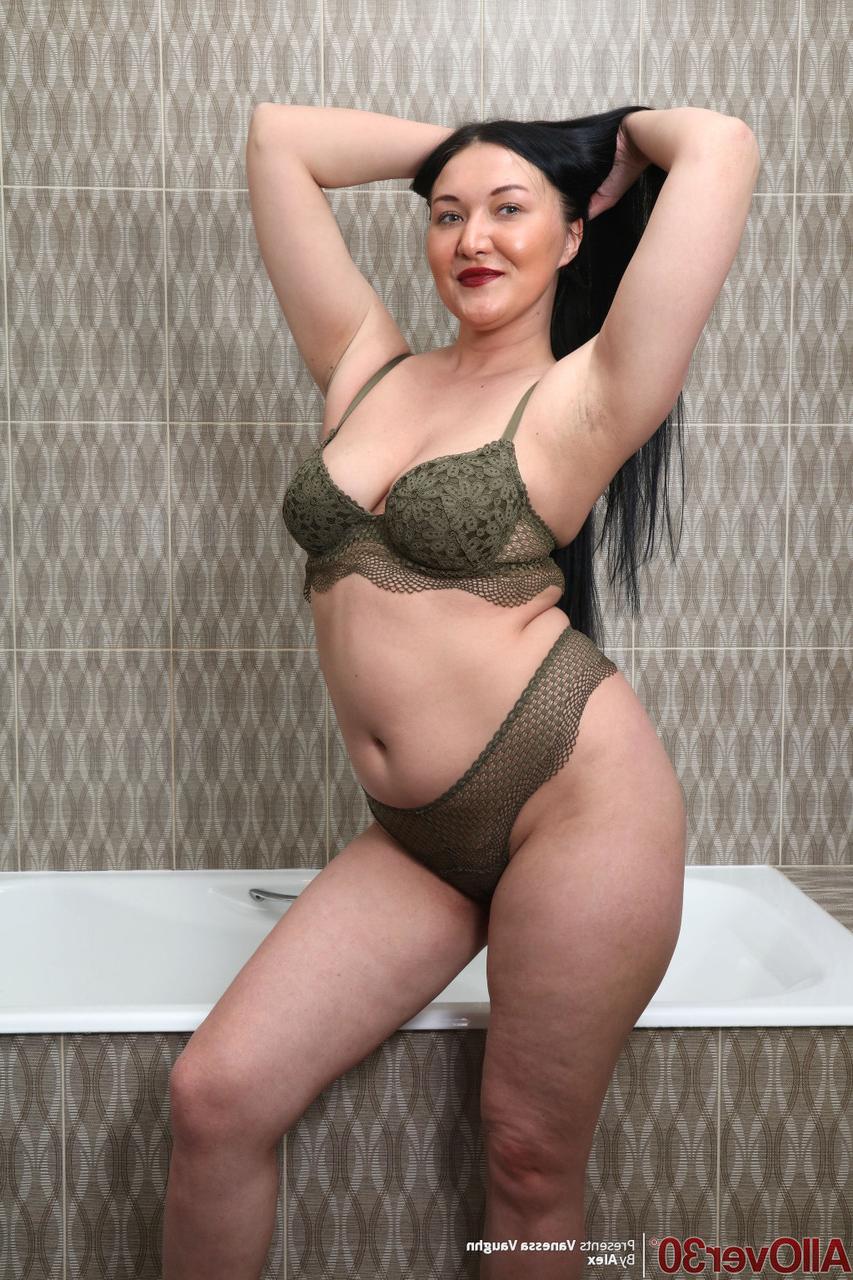 16P Curvy 30 plus brunette Vanessa Vaughn brushes her long hair before bathing