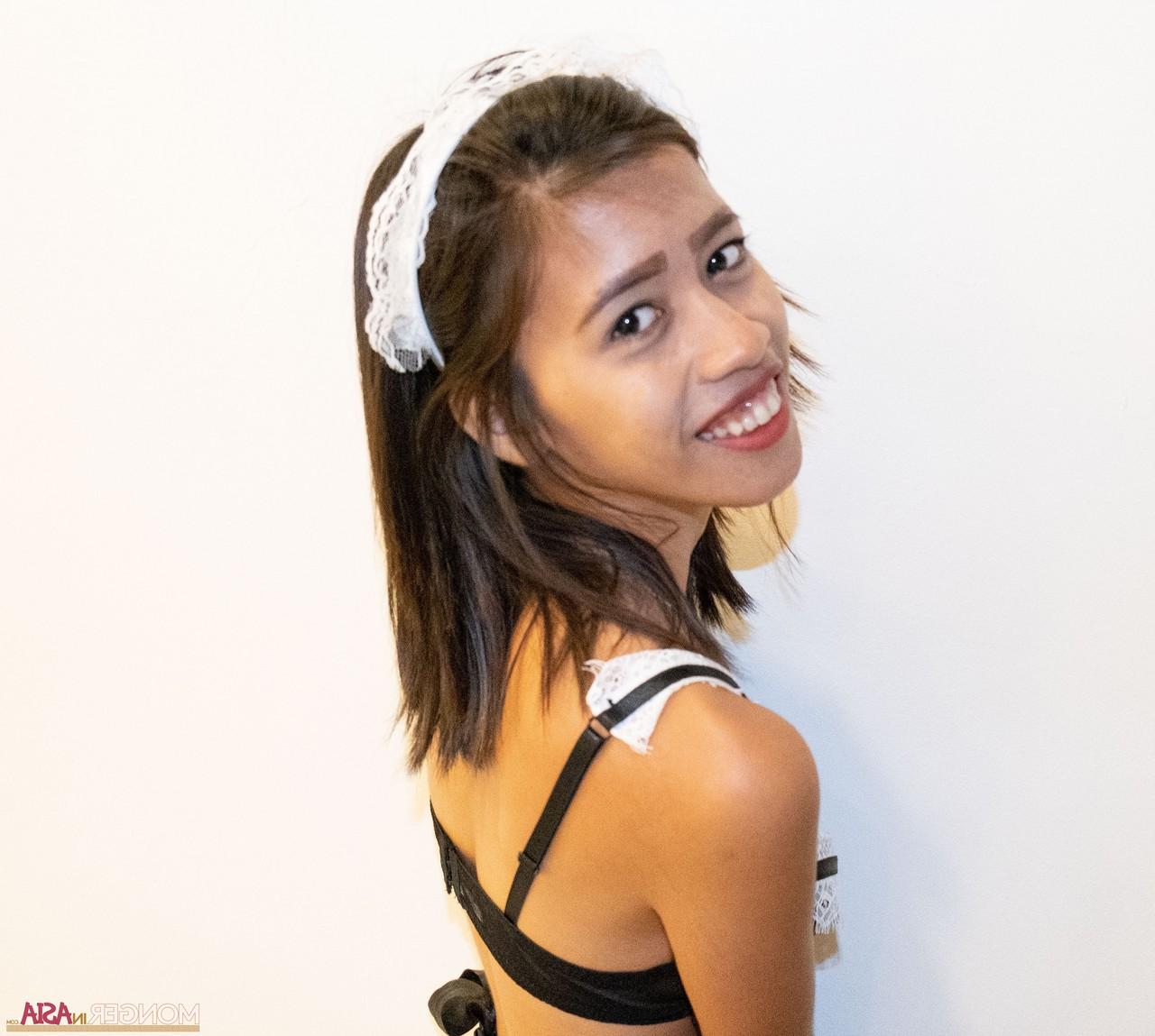 10P Tiny Asian maid Danica posing in her uniform and unveiling her boobs