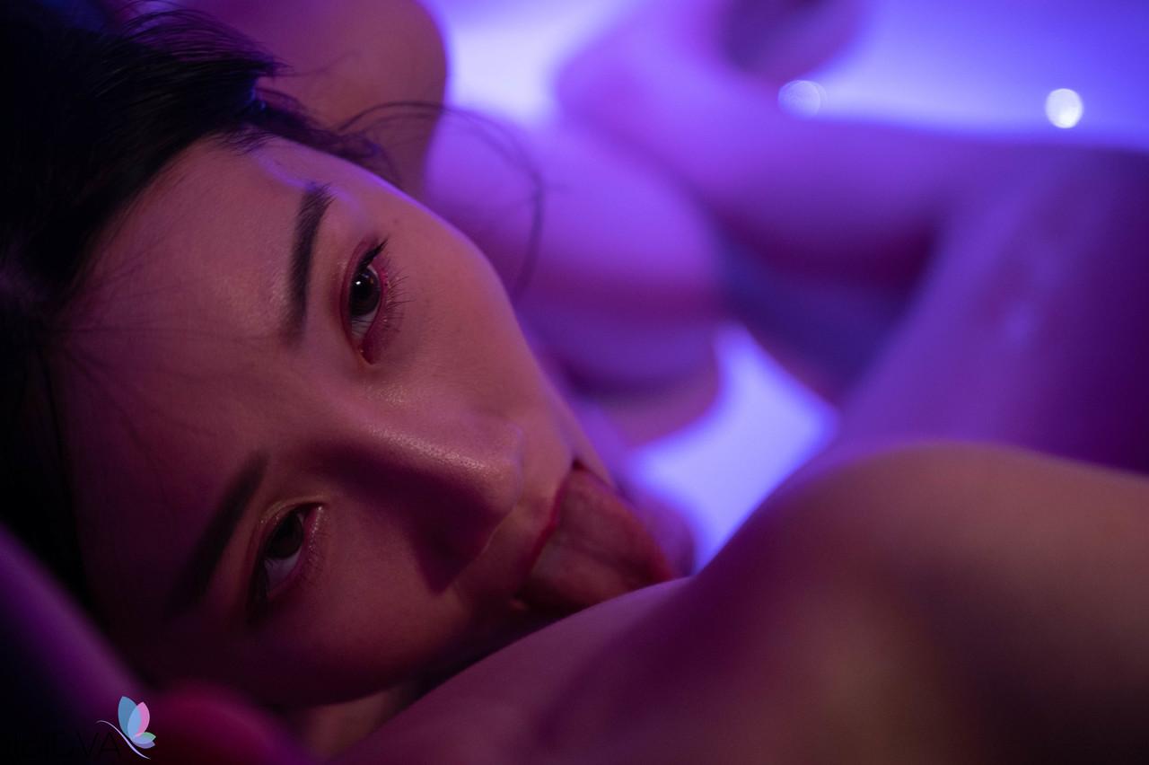 20P Asian masseuse Li Er teases with her big tits during a sensual massage session