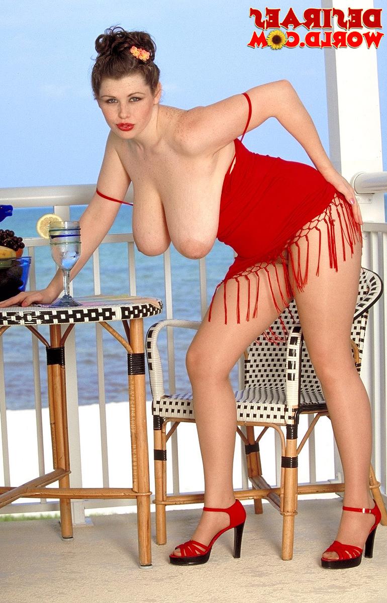 17P Luscious brunette Desirae plays with her massive knockers at the beach bar