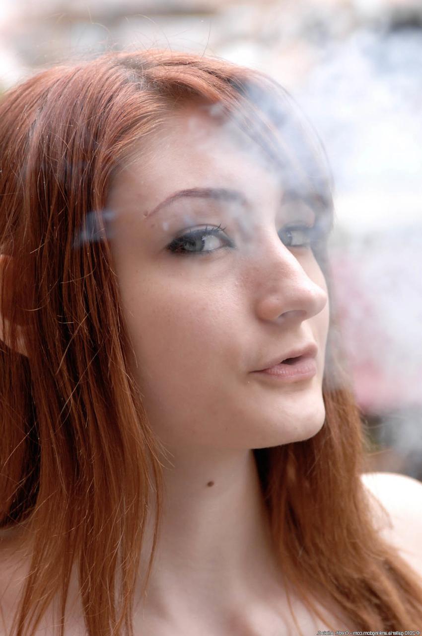 20P Redheaded smoker Violet Monroe flaunts her big ass in an outdoor striptease