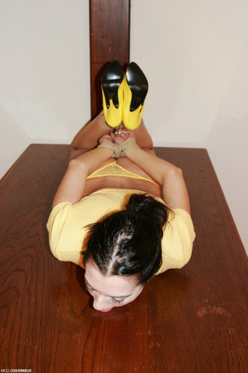 20P Brunette with a pontytail Leyla poses bound in her yellow shirt & panties
