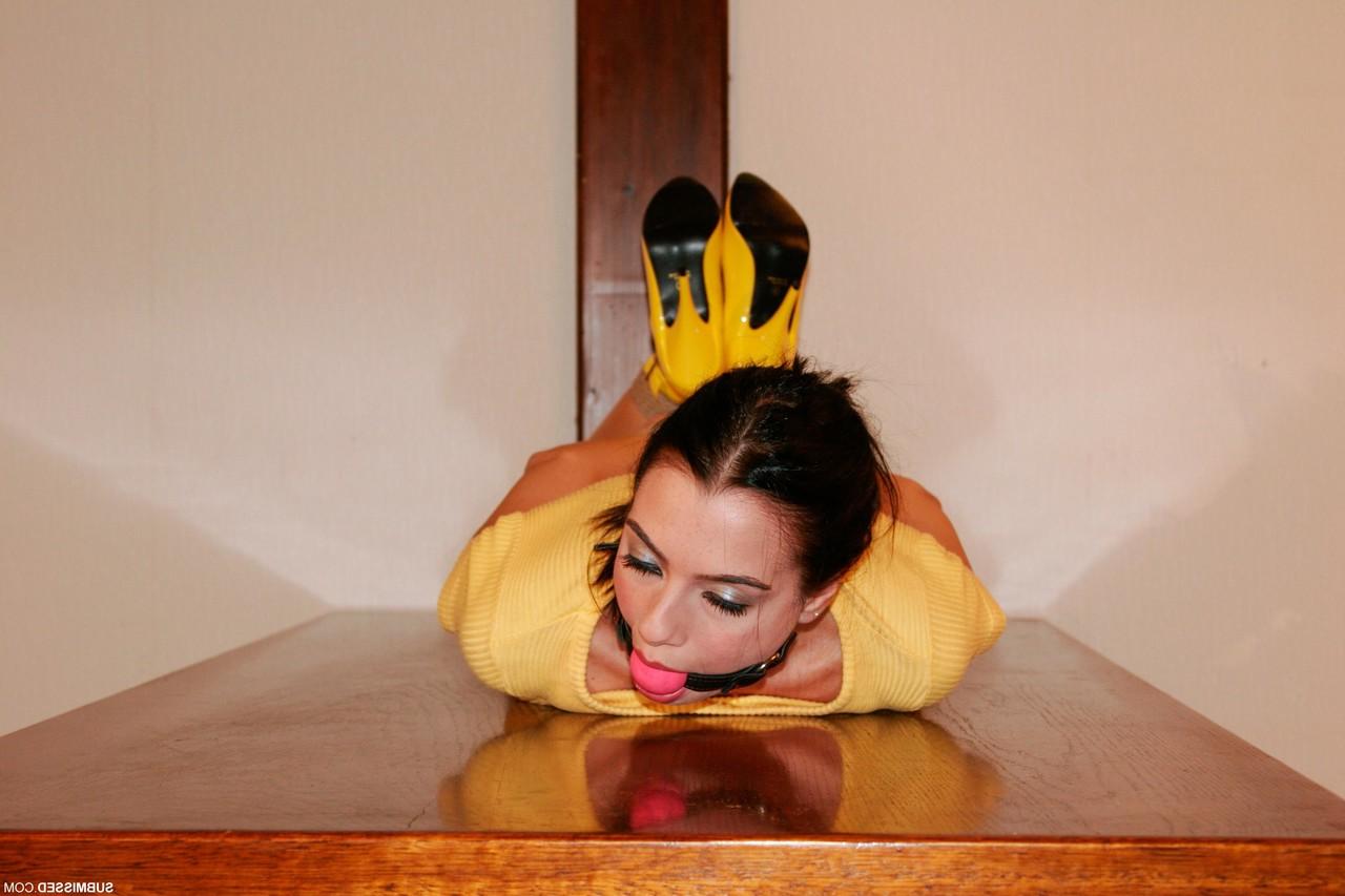 20P Brunette with a pontytail Leyla poses bound in her yellow shirt & panties