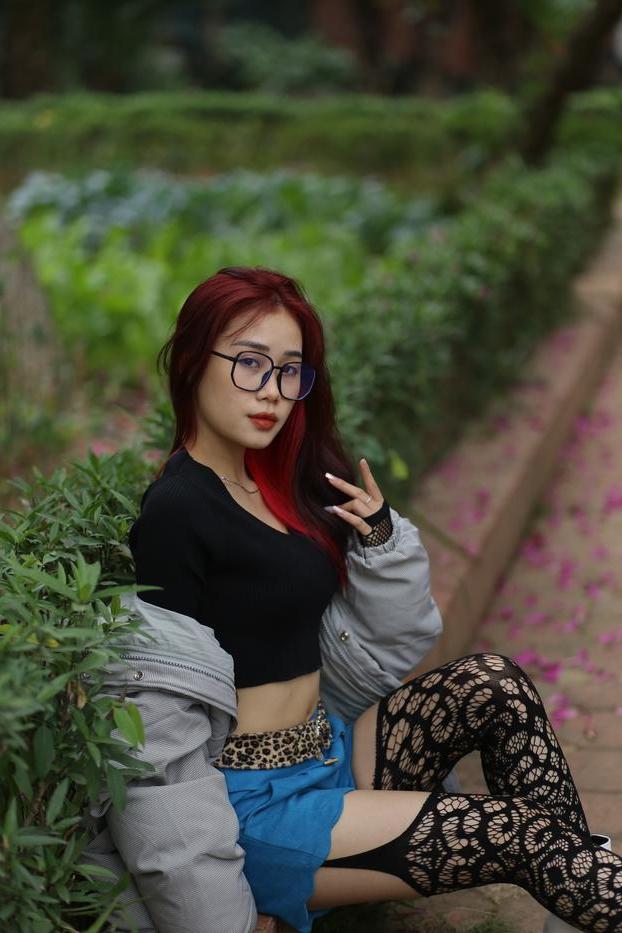 20P Nerdy Asian babe Natalia posing in her slutty outfit in the garden