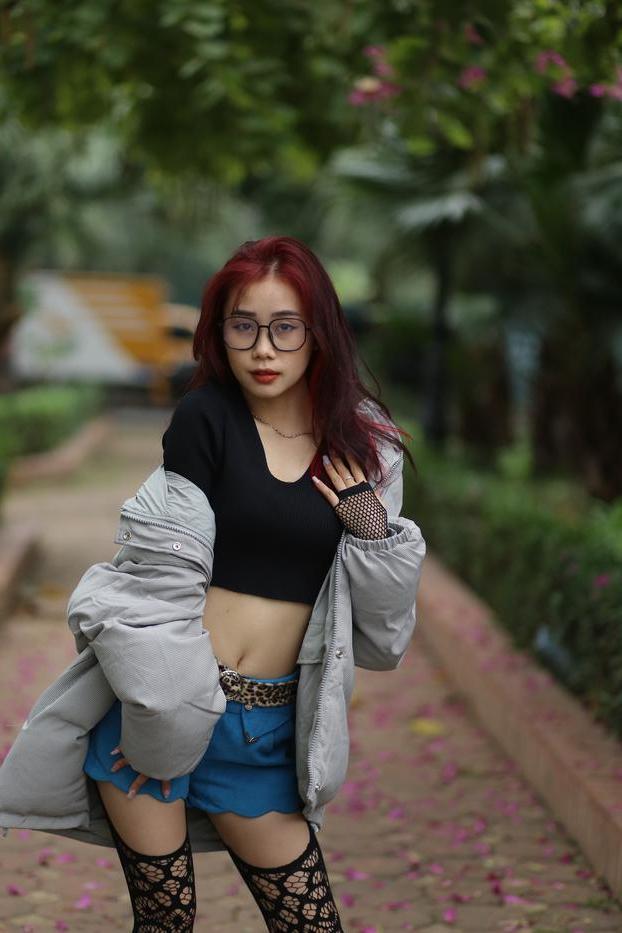 20P Nerdy Asian babe Natalia posing in her slutty outfit in the garden