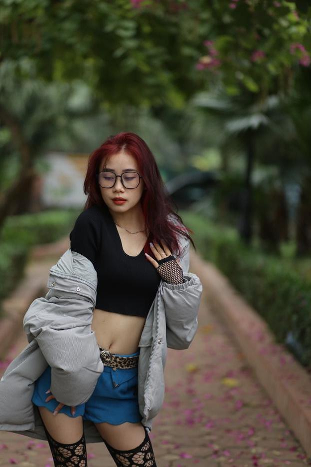 20P Nerdy Asian babe Natalia posing in her slutty outfit in the garden
