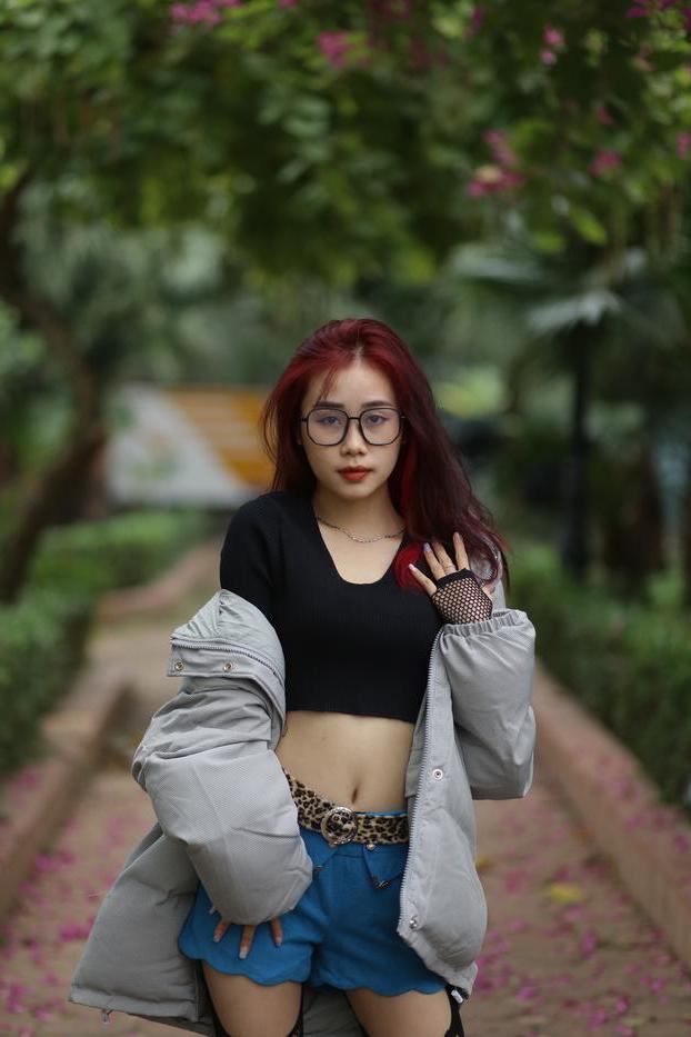 20P Nerdy Asian babe Natalia posing in her slutty outfit in the garden