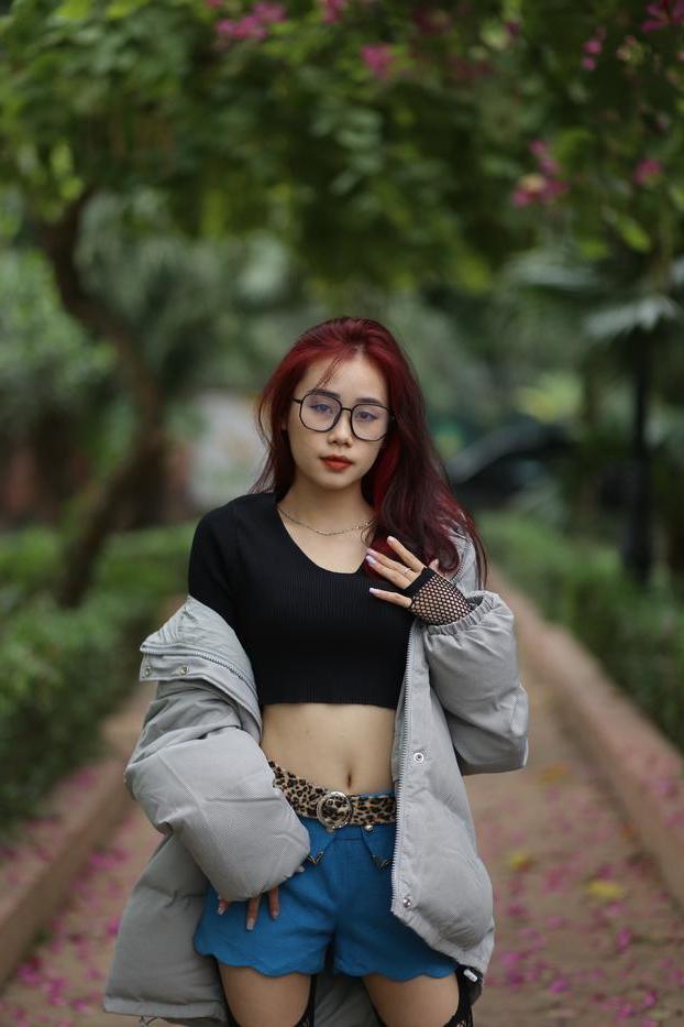 20P Nerdy Asian babe Natalia posing in her slutty outfit in the garden