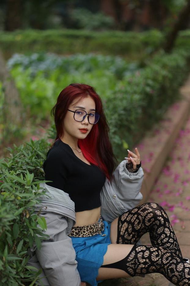 20P Nerdy Asian babe Natalia posing in her slutty outfit in the garden