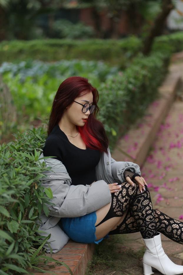 20P Nerdy Asian babe Natalia posing in her slutty outfit in the garden