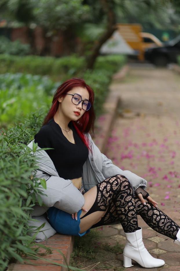 20P Nerdy Asian babe Natalia posing in her slutty outfit in the garden