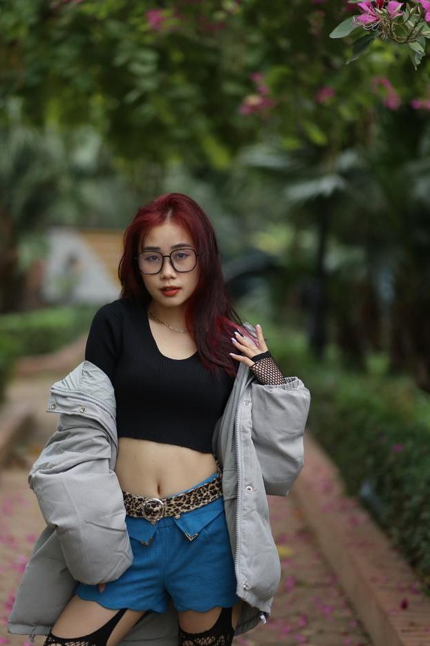20P Nerdy Asian babe Natalia posing in her slutty outfit in the garden