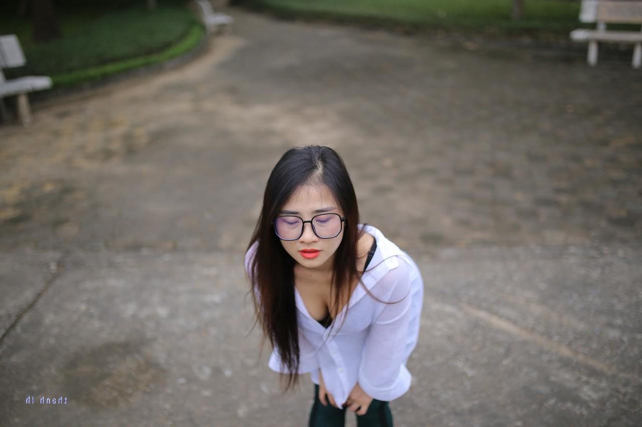 20P Pretty Asian babe Elena posing in her white shirt and pants outdoors