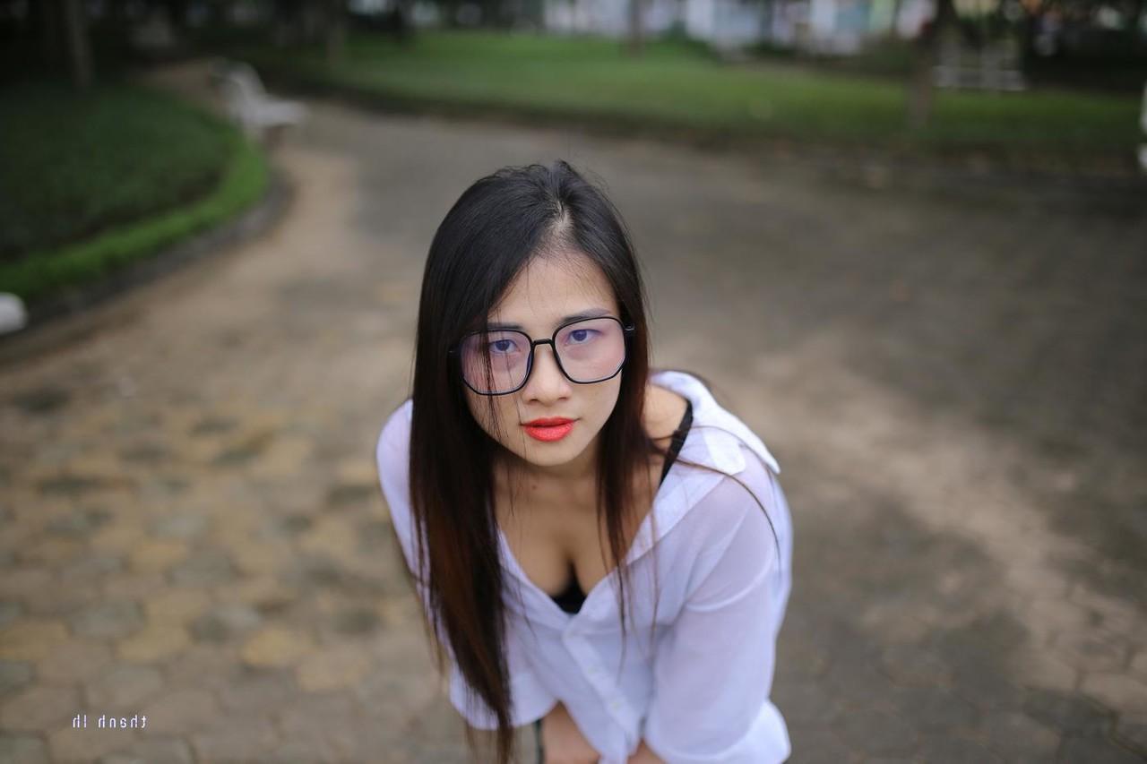 20P Pretty Asian babe Elena posing in her white shirt and pants outdoors