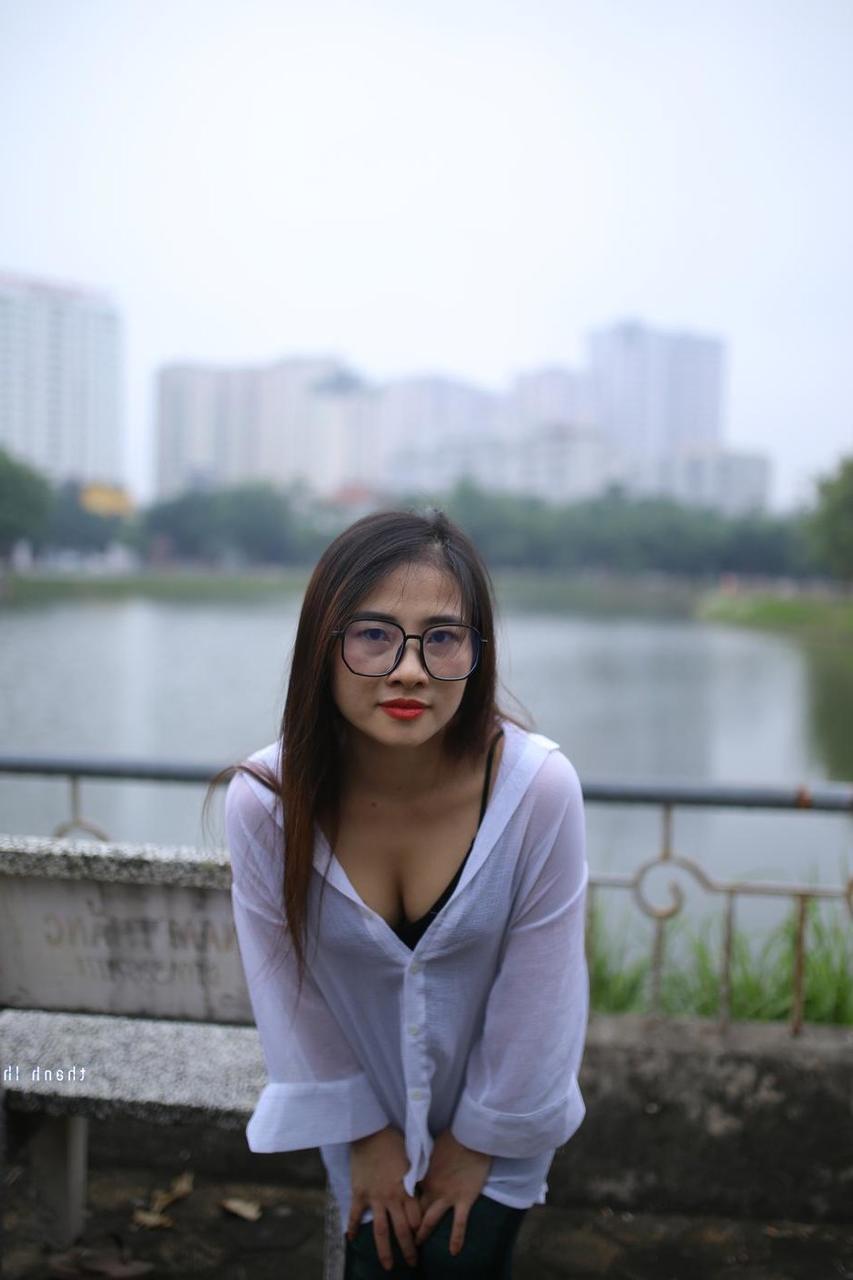 20P Pretty Asian babe Elena posing in her white shirt and pants outdoors