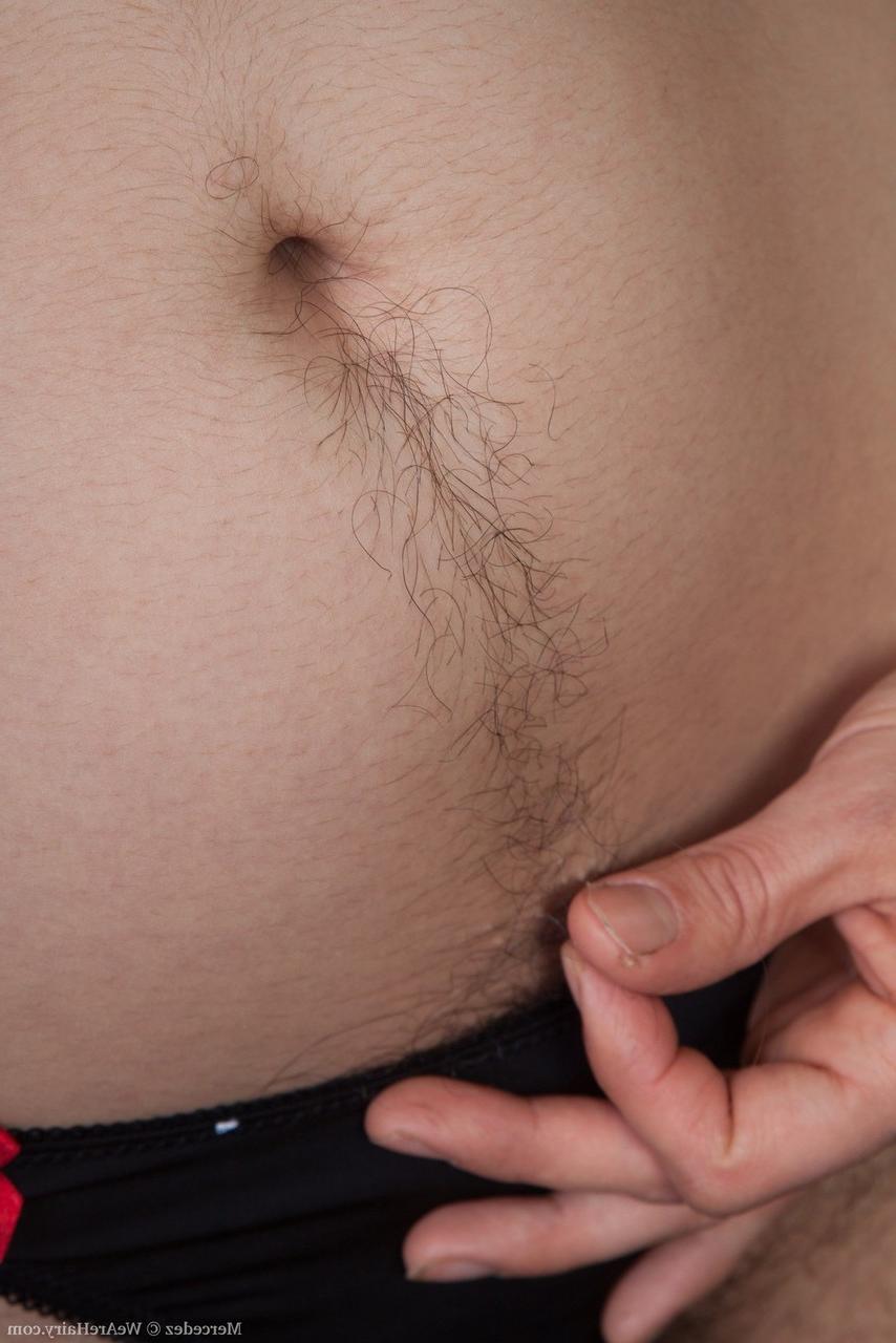 16P Plump solo model Mercedez uncovers her unshaven body as she strips