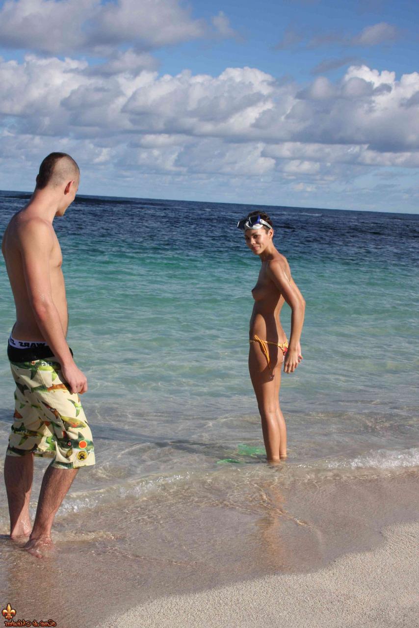 16P Beautiful brunette goes topless on a sandy beach on a nice day