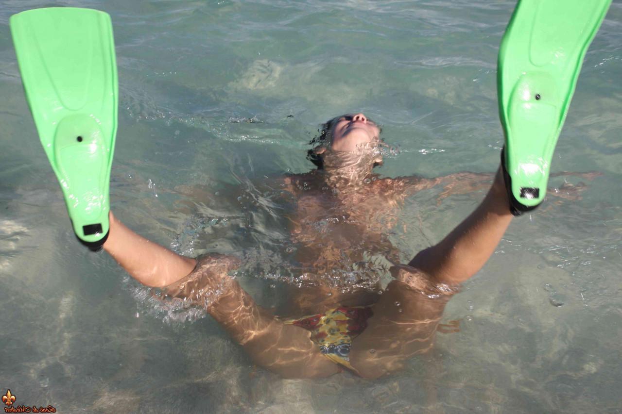 16P Beautiful brunette goes topless on a sandy beach on a nice day