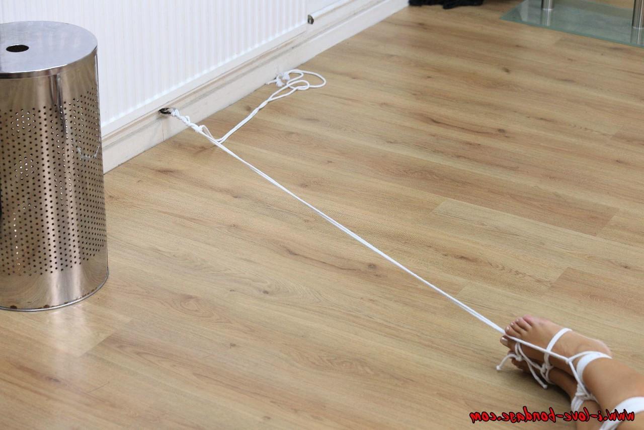 16P White girl is tied up with rope in a black bra and panty ensemble