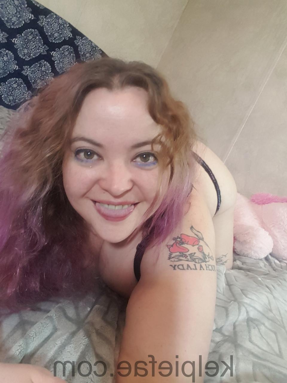 15P Inked chubby amateur Kelpie Fae poses in black underwear on her bed