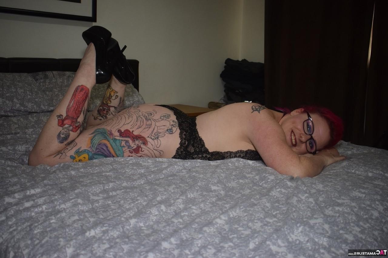 16P A amadora tatuada Mollie Foxxx modela lingerie preta com óculos