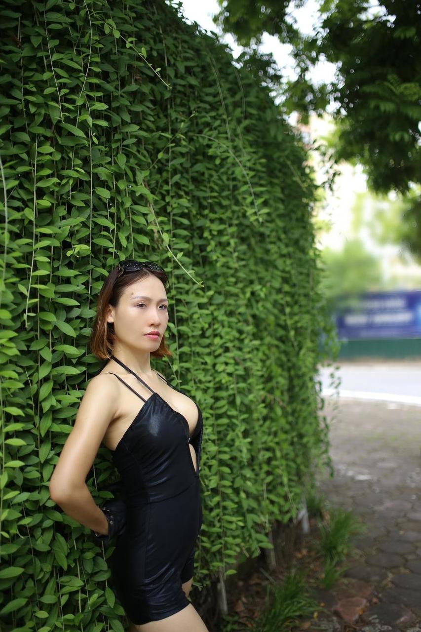 20P Marvelous Asian babe Julia Ly Ly poses in her provocative black dress outside
