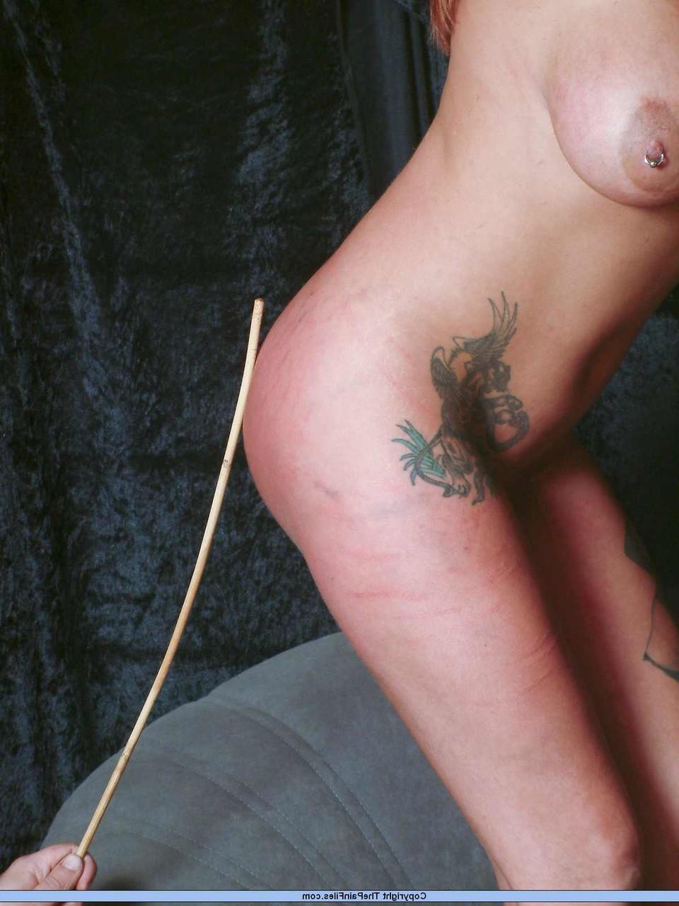16P Busty blonde is caned while restrained in her birthday suit