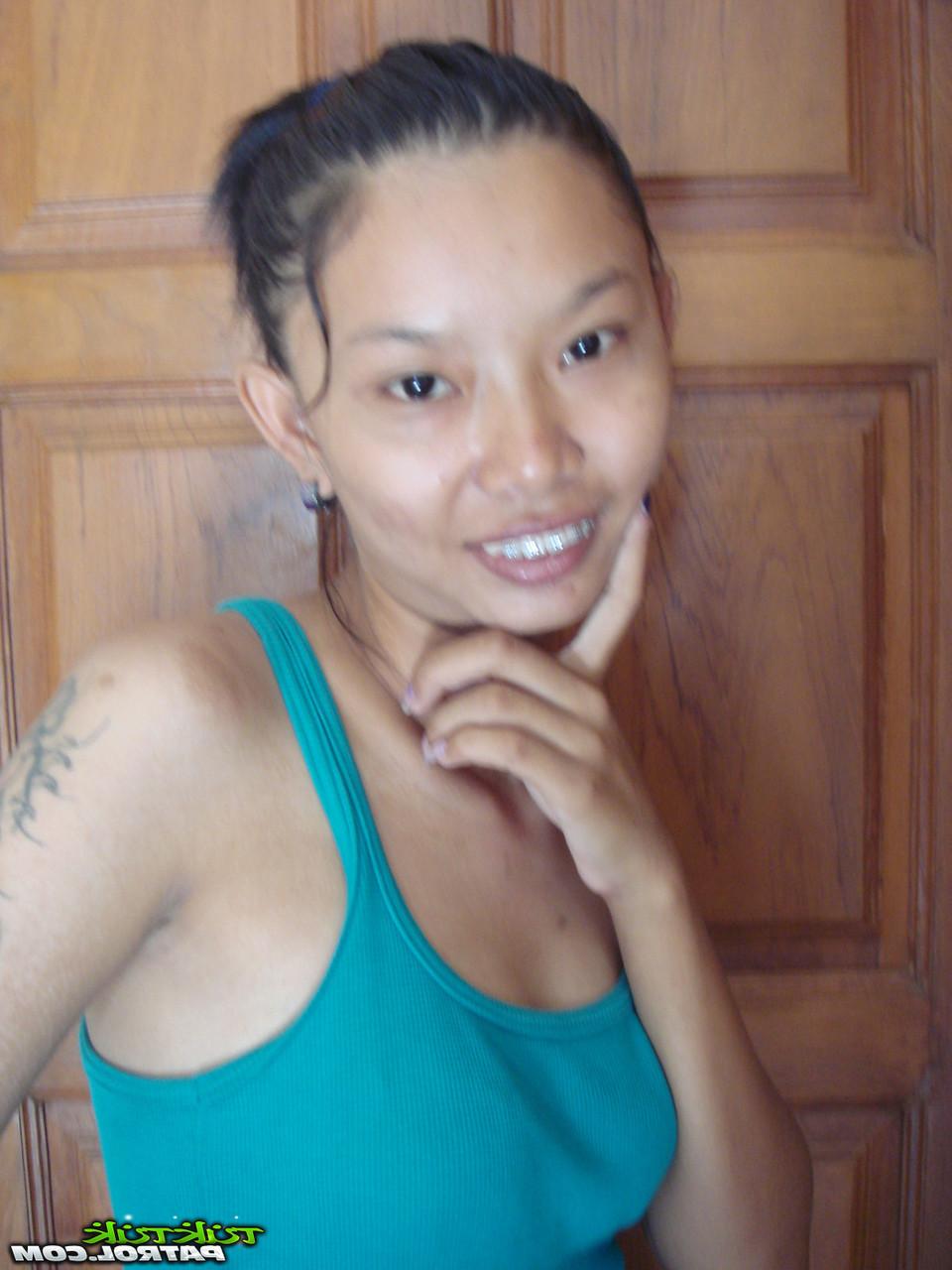 20P Das dünne asiatische Babe Tik enthüllt ihre kleinen Titten und ihre rasierte Muschi