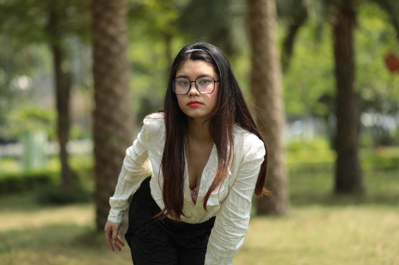 20P Das nerdige asiatische Babe Natalia posiert in ihrem eleganten Outfit im Freien