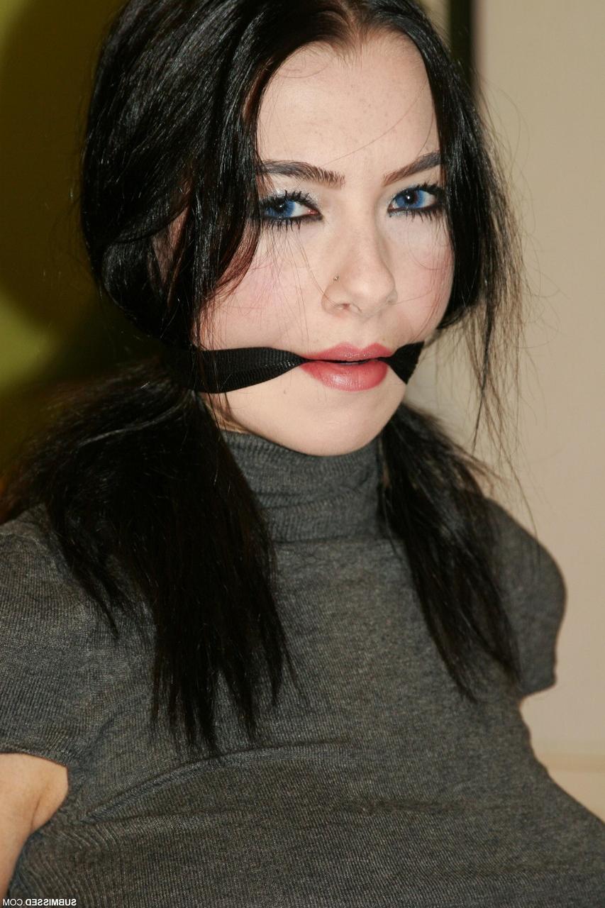 20P Braless brunette Leyla gagged and tied to a chair in a shirt, jeans & boots