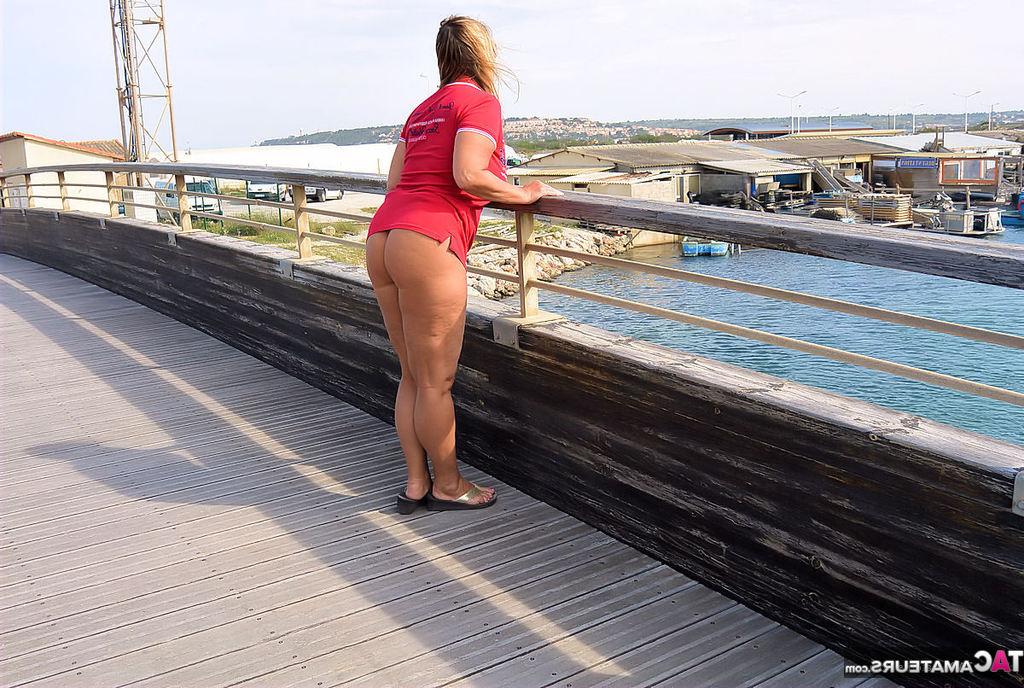 20P Mature fatty Chrissy walks by the sea with her round big tits bared