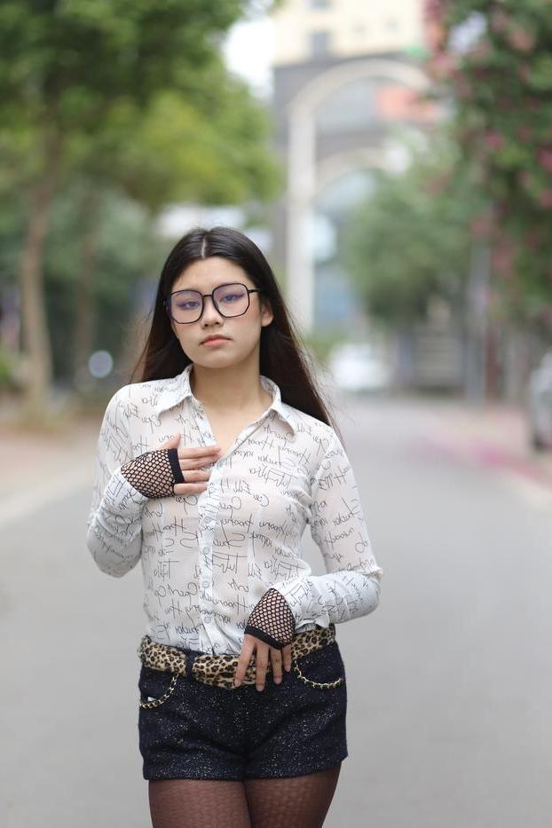 20P Nerdy Asian babe Natalia posing in her white blouse and denim shorts outside