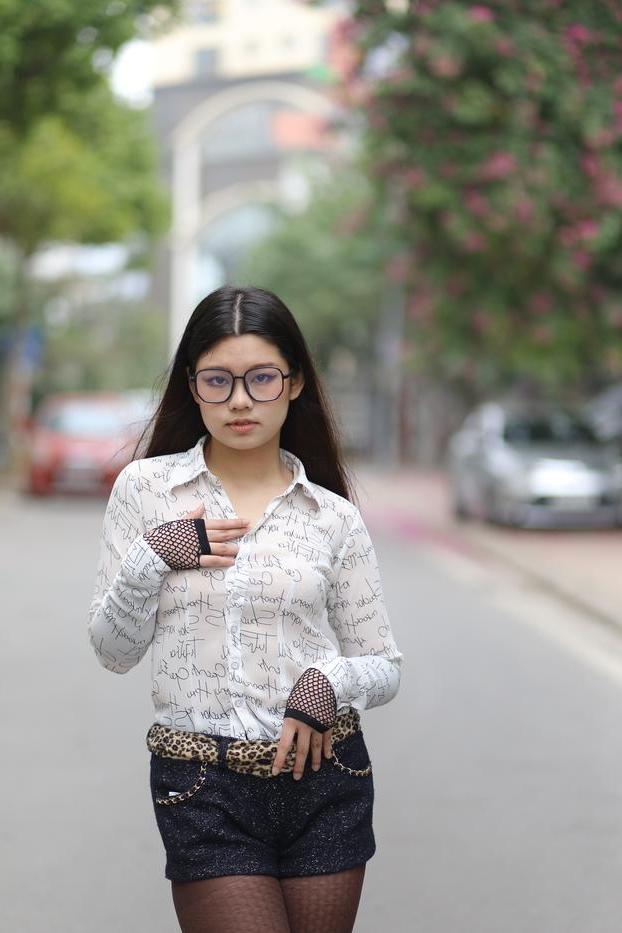 20P Nerdy Asian babe Natalia posing in her white blouse and denim shorts outside