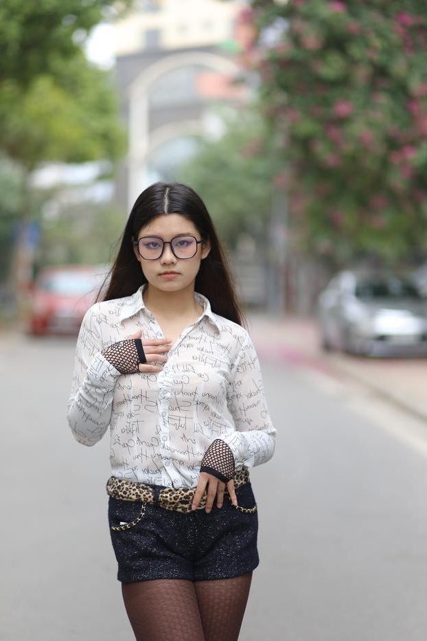 20P Nerdy Asian babe Natalia posing in her white blouse and denim shorts outside