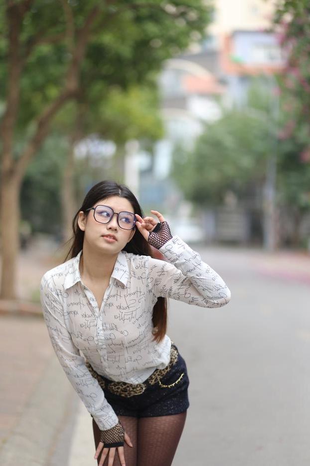 20P Nerdy Asian babe Natalia posing in her white blouse and denim shorts outside