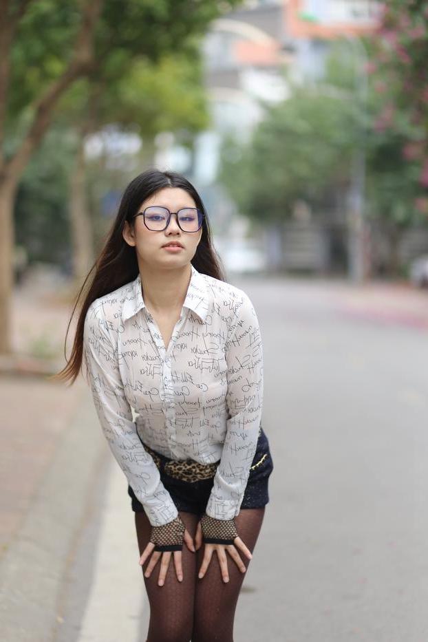20P Nerdy Asian babe Natalia posing in her white blouse and denim shorts outside