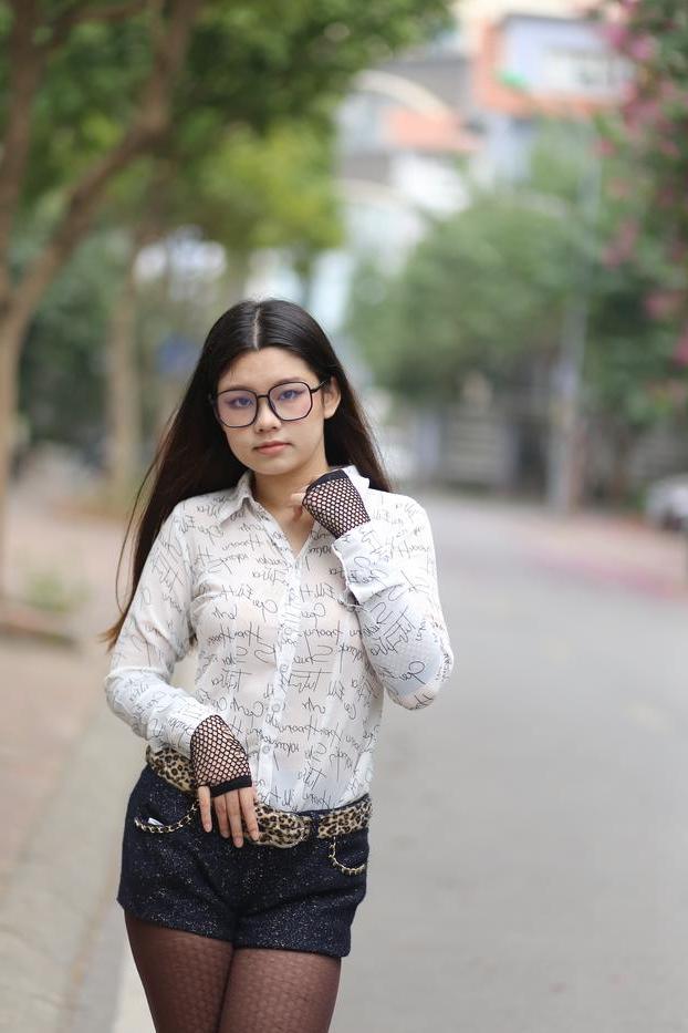 20P Nerdy Asian babe Natalia posing in her white blouse and denim shorts outside