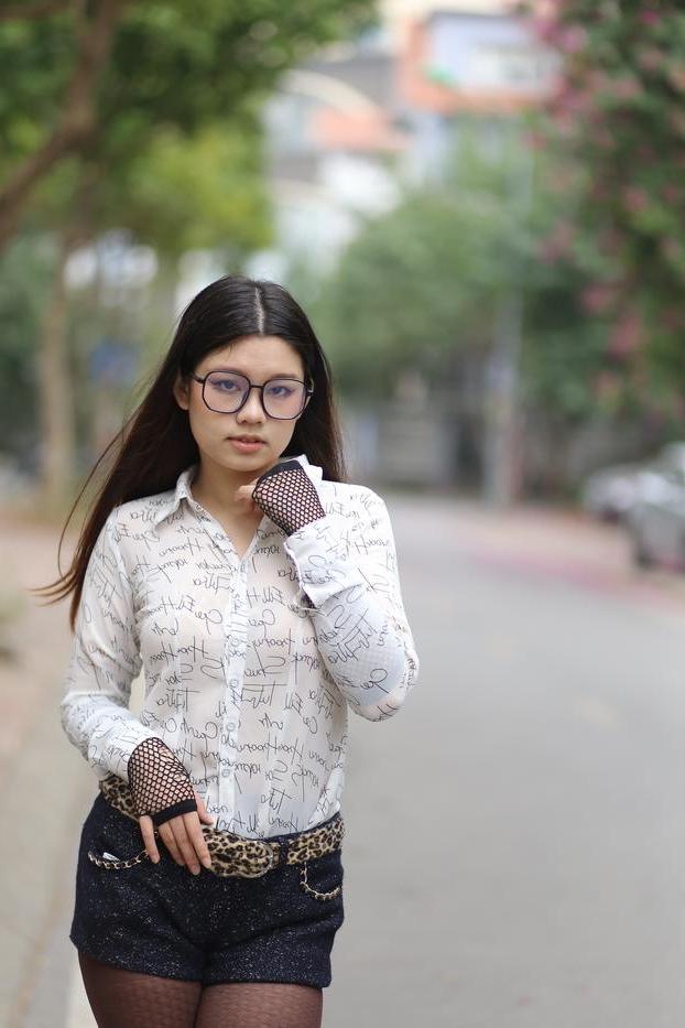 20P Nerdy Asian babe Natalia posing in her white blouse and denim shorts outside